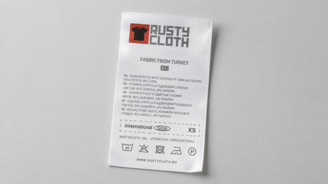 Standalone white garment label with Rusty Cloth branding, sizing and care information.