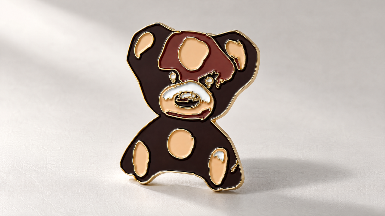 Bear-shaped enamel pin for Rusty Cloth.